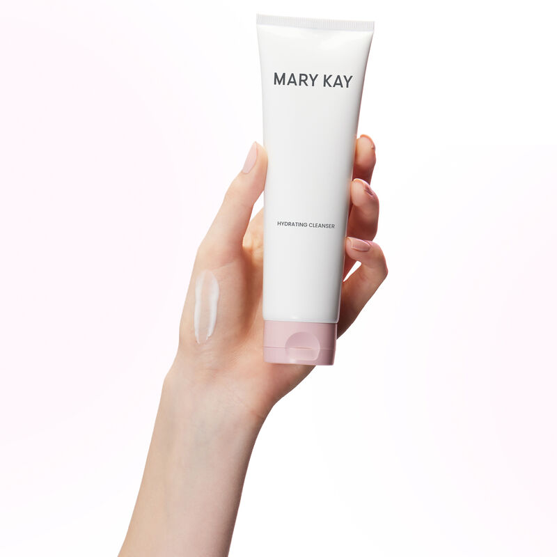 Hand holding tube of Mary Kay Hydrating Cleanser with product rub on the hand image number null