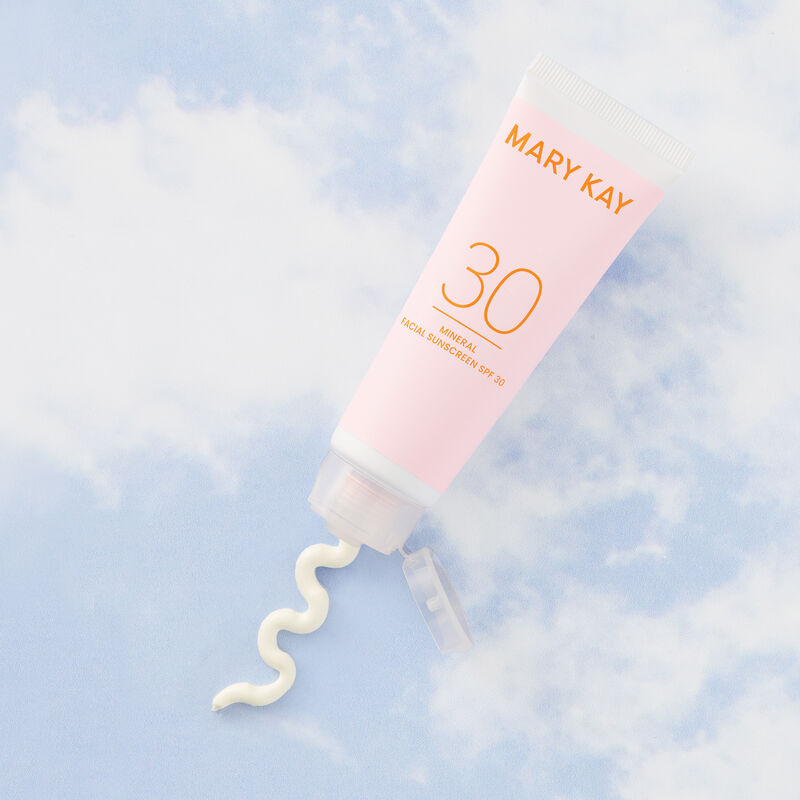 Mary Kay&reg; Mineral Facial Sunscreen with squirt of product on a sky background.
