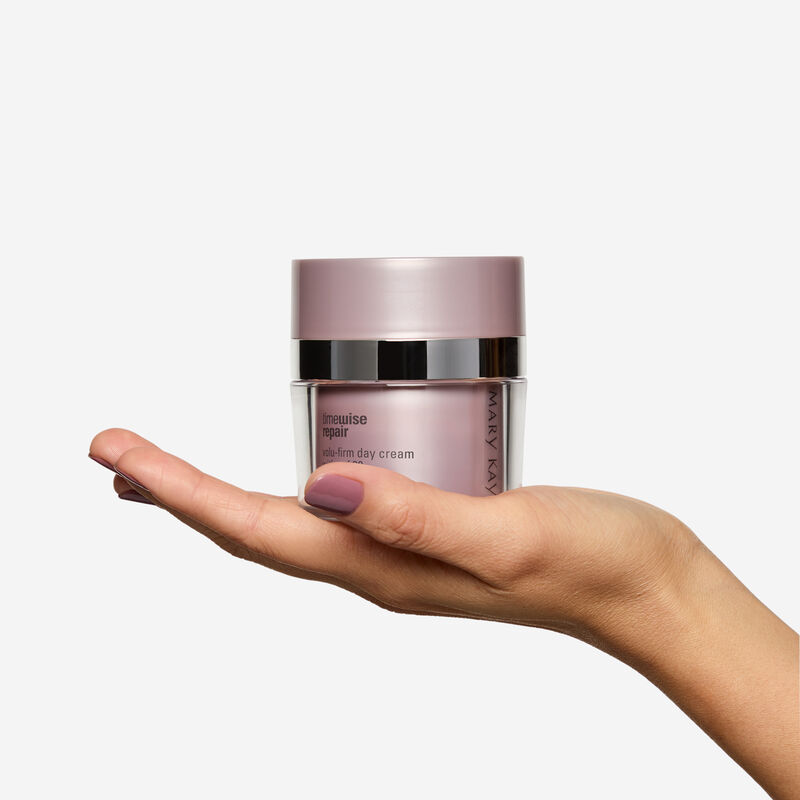 Hand holding Day Cream jar