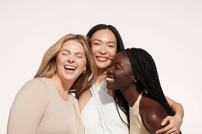 A group of three smiling women.