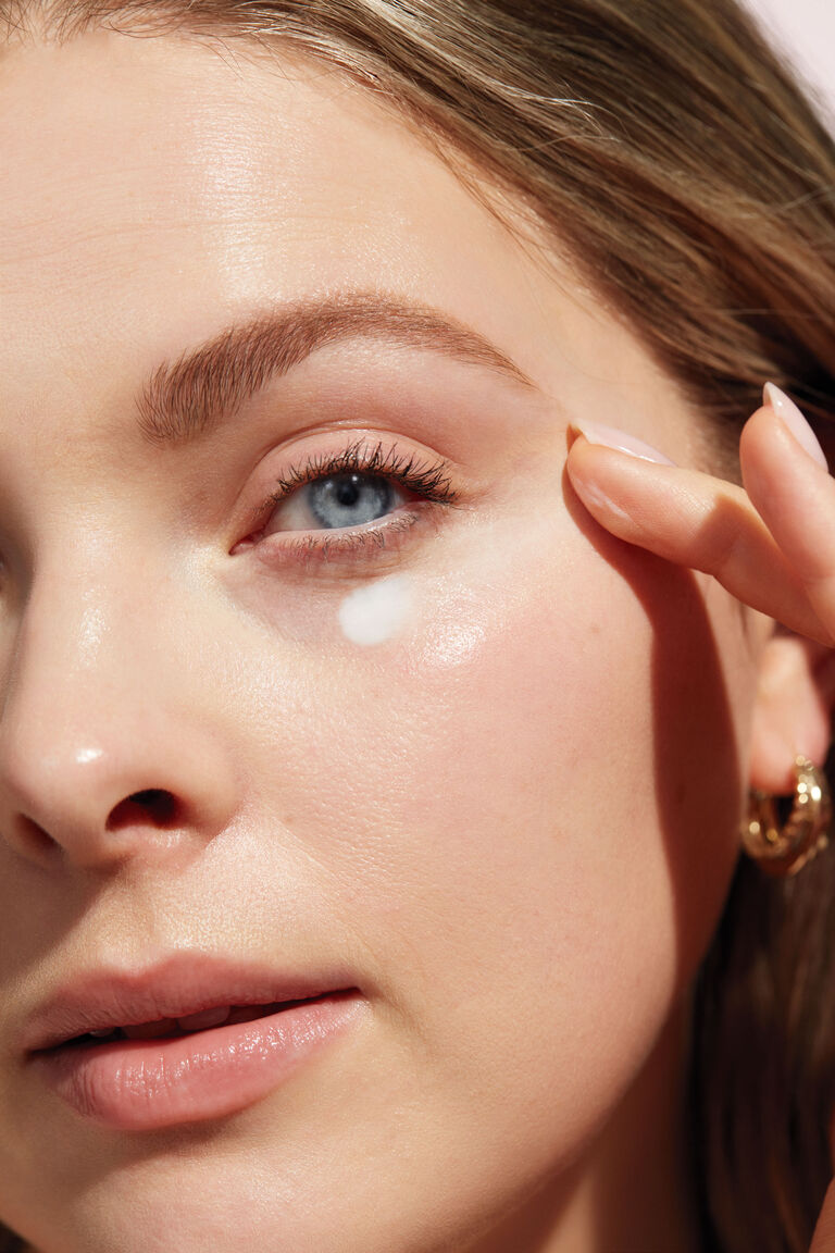 A close up of a woman's face with Mary Kay Timewise eye cream.