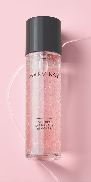 Bouteille du D&eacute;maquillant sans huile pour les yeux Mary Kay agit&eacute;e sur un fond rose