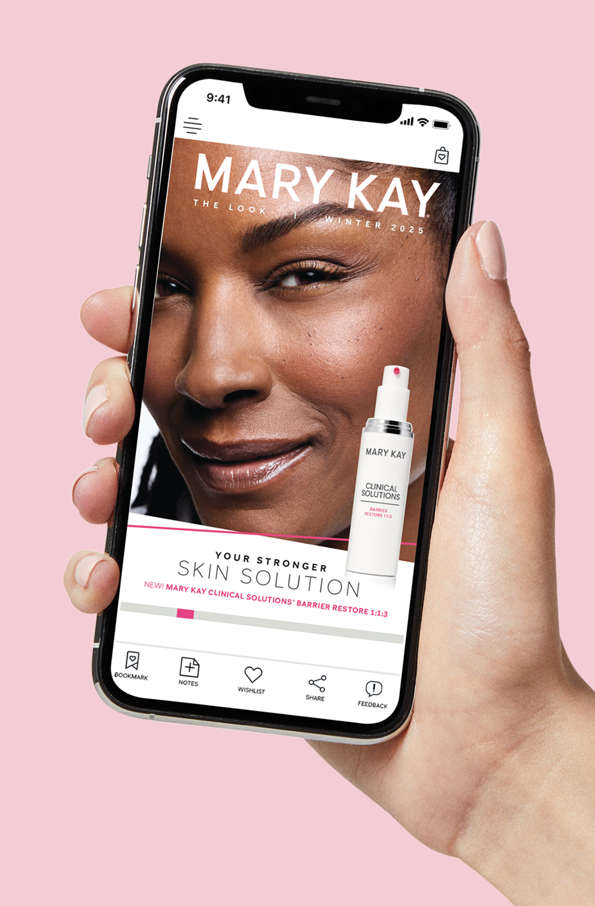 Hand hold the Mary Kay Look Book.