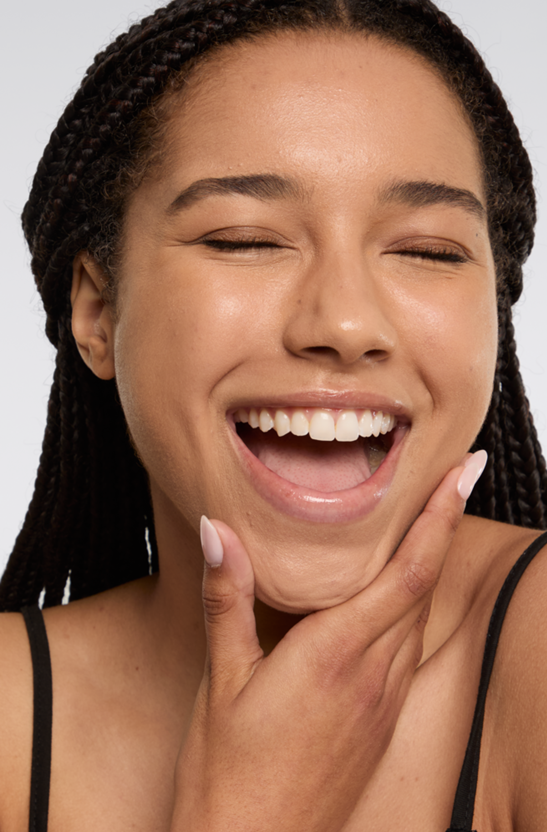 A person touches their chin with one hand.