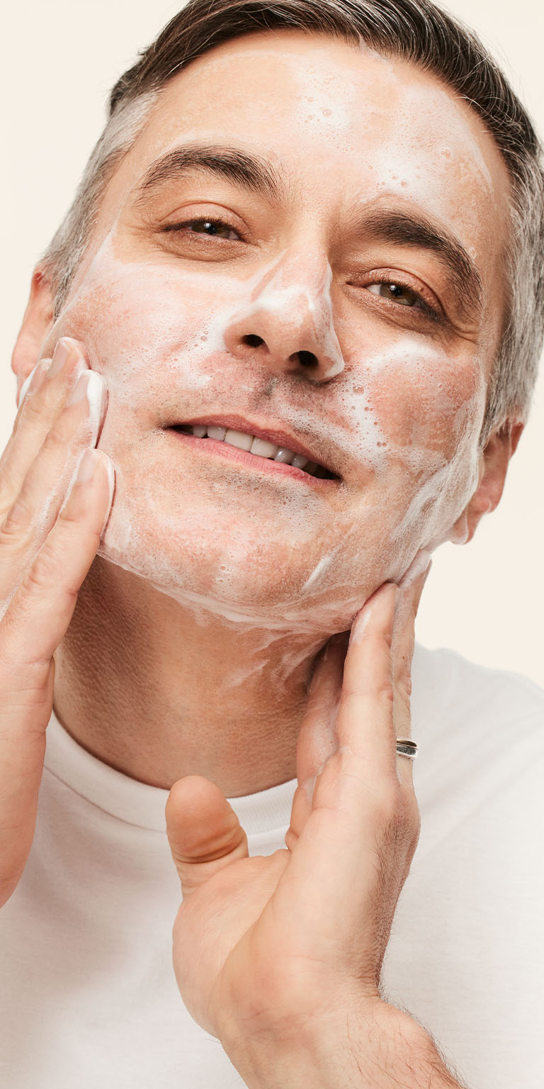 Male model applying Mary Kay MKMen Daily Facial Wash to his face