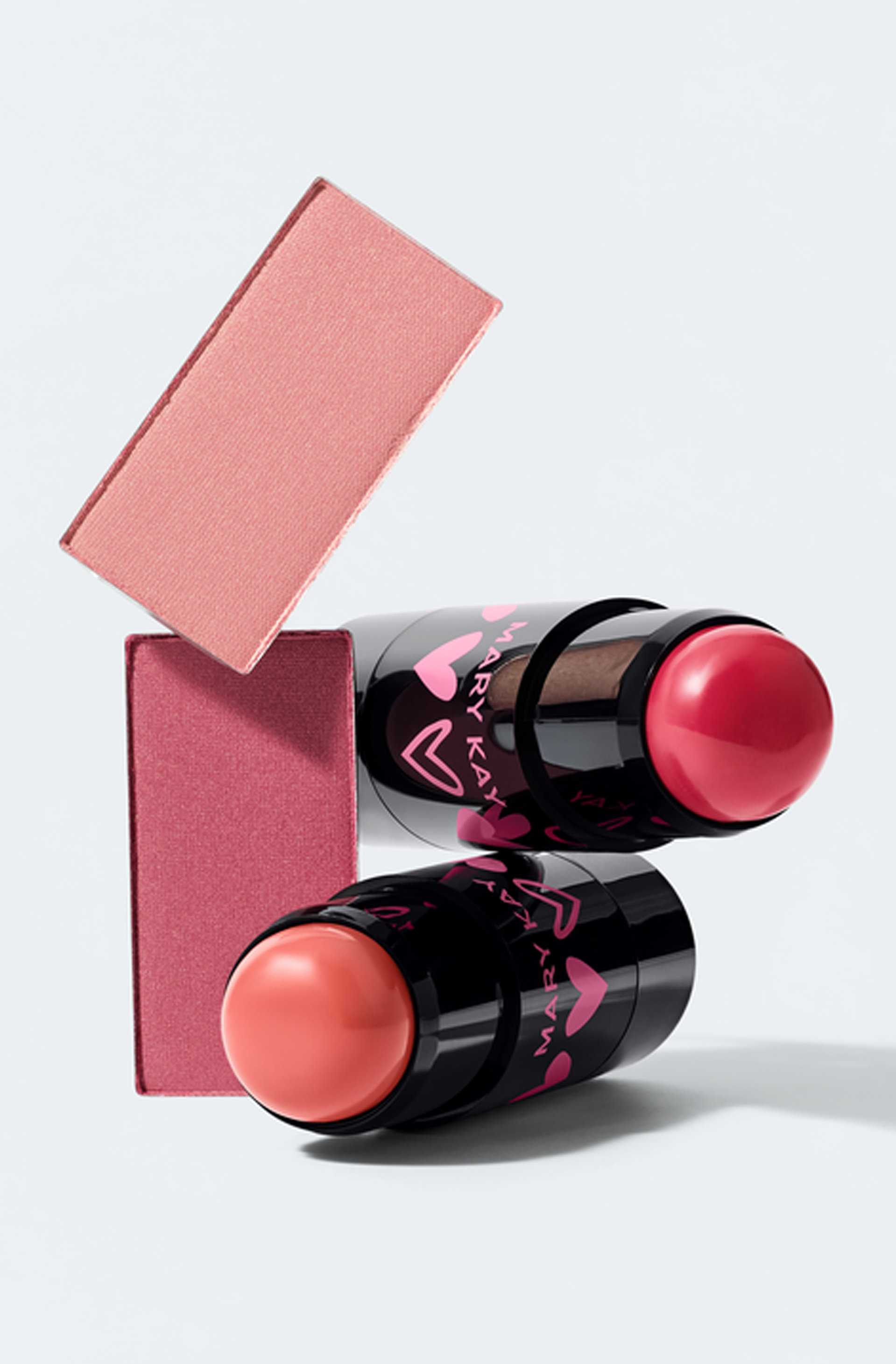 Mary Kay Cream Blush Sticks standing beside Mary Kay Chromafusion Cheek pans.