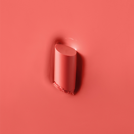 Texture rub of Mary Kay Supreme Hydrating Lipstick in shade Coral Confetti